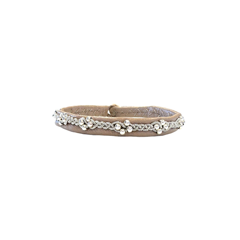 Handcrafted Sami bracelet in beige leather with silver beads shaped like cloudberries and pewter braid.
