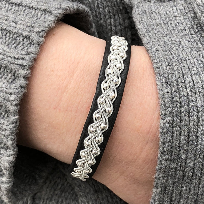 handcrafted leather bracelet with silver beads and reindeer antler button. Elegant, feminine, Nordic design.